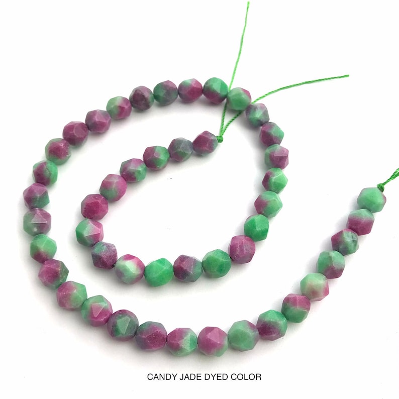 May include: Strands of faceted candy jade beads in shades of green and magenta. The beads are strung on green thread. The text "CANDY JADE DYED COLOR" is at the bottom of the image.