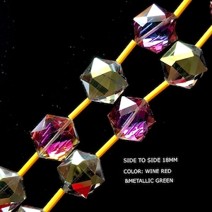 May include: A strand of faceted glass beads with a wine red and metallic green color. The beads are 18mm side to side.  SIDE TO SIDE 18MM COLOR: WINE RED &METALLIC GREEN