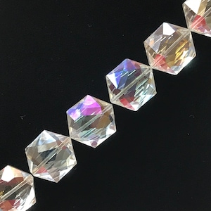 May include: A strand of iridescent clear glass beads with a faceted hexagonal shape.