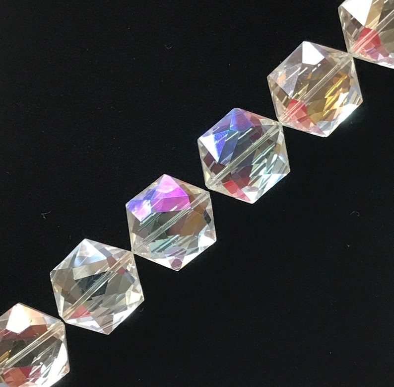May include: A strand of iridescent clear glass beads with a faceted hexagonal shape.