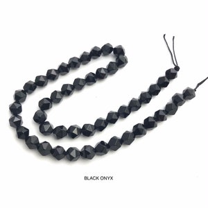 May include: Strands of faceted black onyx beads. The beads are strung on black thread and are displayed against a white background. The text "BLACK ONYX" is at the bottom of the image.