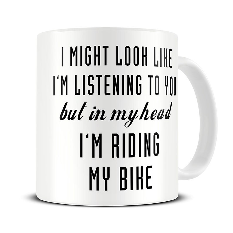 May include: White ceramic coffee mug with black text that reads "I might look like I'm listening to you but in my head I'm riding my bike."