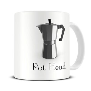 May include: White ceramic mug featuring a black and silver coffee pot illustration and the text "Pot Head" printed on the front.