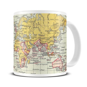May include: A white ceramic mug featuring a vintage world map design. The map is in shades of yellow, red, and brown, with the continents outlined in black. The mug has a handle on the right side.