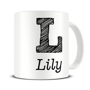 May include: White ceramic mug with a black and white illustration of the letter L and the name "Lilly" printed below.