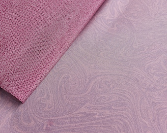 May include: Two pieces of fabric, one a solid deep pink with a textured surface and the other a light pink with a swirling marbled pattern.