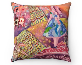 Pode incluir: Uma almofada colorida com uma pintura fantasiosa de Alice no País das Maravilhas. A almofada representa Alice com um vestido azul com um laço rosa, em pé em um cogumelo gigante com um coelho branco e um cartão de jogo no fundo.