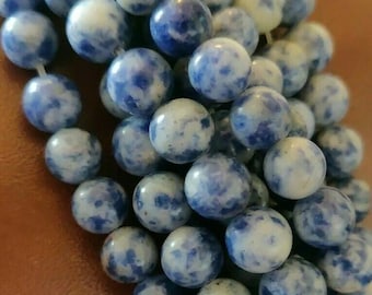 May include: A strand of blue and white gemstone beads. The beads are round and have a marbled appearance.