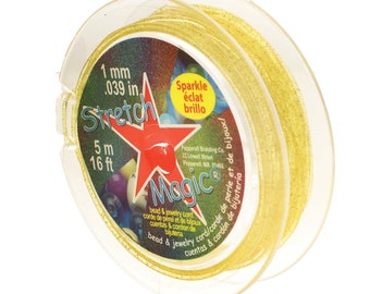 May include: A spool of gold stretch magic bead and jewelry cord. The spool is labeled with the text "Stretch Magic" and "1 mm .039 in 5 m 16 ft".