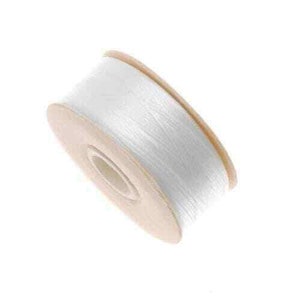 May include: A spool of white thread. The thread is tightly wound around a light brown cardboard core. The spool is angled slightly, showcasing the texture of the thread and the construction of the spool.
