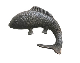 Vintage Cast iron fish with hook tail.