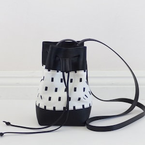 Mini vegan bucket bag with screen printed canvas and black leather