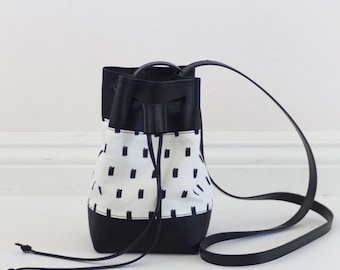 Mini vegan bucket bag with screen printed canvas and black leather