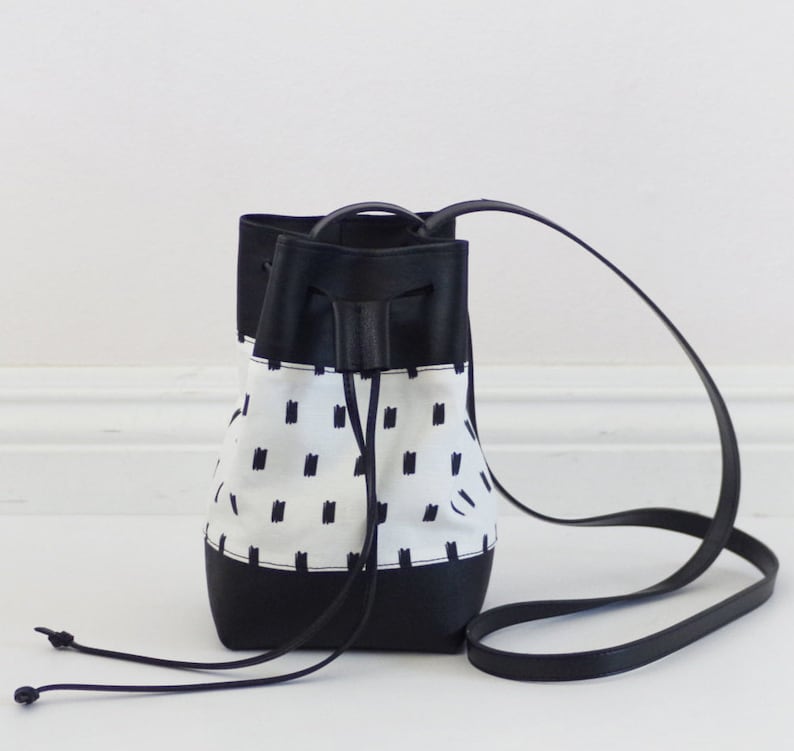 Mini vegan bucket bag with screen printed canvas and black leather 