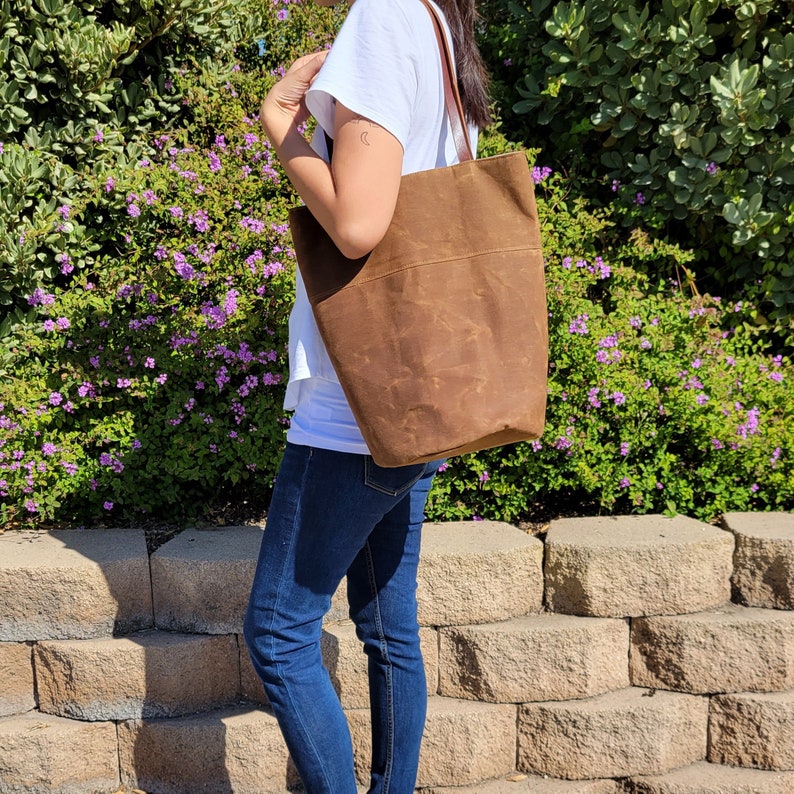 Waxed canvas tote bag with leather handles and round bottom image 1