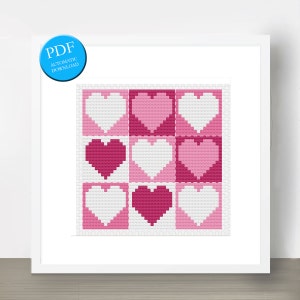 May include: A cross stitch pattern featuring a grid of nine pink and white hearts. The pattern is framed in a white frame.