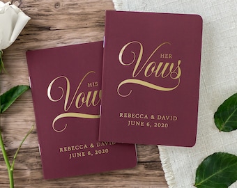 May include: Two burgundy vow books with gold lettering. The top book says "HER VOWS" and the bottom book says "HIS VOWS". Both books have the names "Rebecca & David" and the date "June 6, 2020" printed on them.
