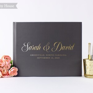 May include: Gray hardcover guest book with gold lettering that reads "Sarah & David" and "Greenville, North Carolina September 12, 2020".