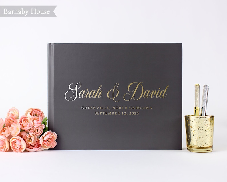 May include: Gray hardcover guest book with gold lettering that reads "Sarah & David" and "Greenville, North Carolina September 12, 2020".