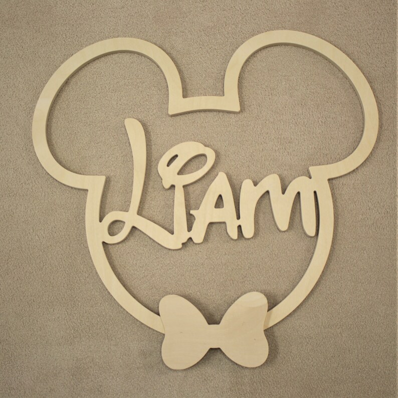 May include: Wooden cutout of Mickey Mouse ears with a bow tie and the name "Liam" in a stylized font.