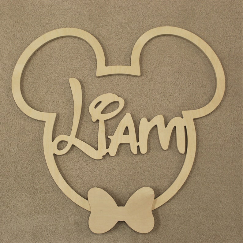 May include: Wooden cutout of Mickey Mouse's head with a bow tie and the name "Liam" written inside.