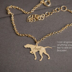 May include: Gold chain bracelet with a pendant shaped like a dog. The pendant is engraved with the name "Angel".