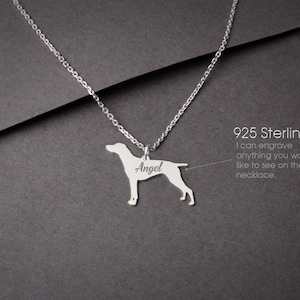 May include: A 925 sterling silver necklace featuring a dog-shaped pendant with the name Angel engraved on the side. The text 925 Sterling Silver and I can engrave anything you would like to see on the necklace are printed on the right side.
