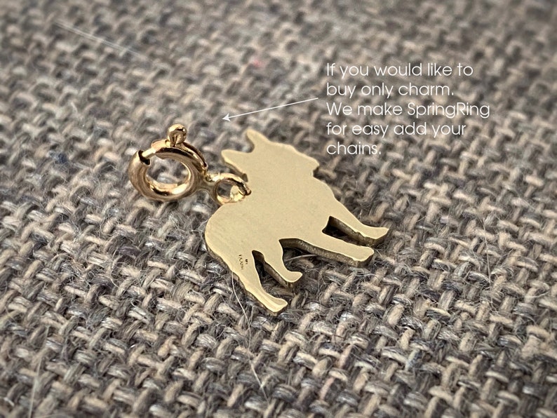 May include: Gold-toned French Bulldog charm with a spring ring for attaching to a chain. The charm is a silhouette of a French Bulldog.