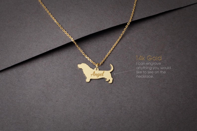 May include: A gold necklace with a basset hound pendant. The pendant is engraved with the name "Angel". 14k Gold. I can engrave anything you would like to see on the necklace.