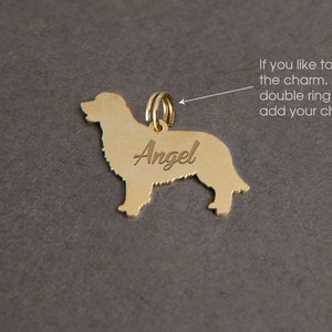 May include: Gold-colored dog charm with the name "Angel" engraved on it. The charm has a double ring for attaching to a chain.