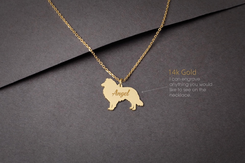 May include: A gold necklace with a pendant shaped like a Collie dog. The pendant is engraved with the name "Angel". The necklace is made of 14k gold and can be engraved with any text.
