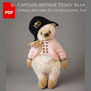 May include: A plush teddy bear wearing a black captain's hat with a gold emblem and a light pink jacket with gold buttons. The bear is approximately 9.8 inches tall and has a cream-colored fur. The image includes the text "CAPTAIN ARTHUR TEDDY BEAR SEWING PATTERN 25 CM INCLUDING HAT."