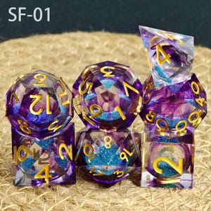 May include: A set of seven polyhedral dice with a purple and blue glitter design. The dice have gold numbering and are made of a clear resin material. The text "SF-01" is in the top left corner.