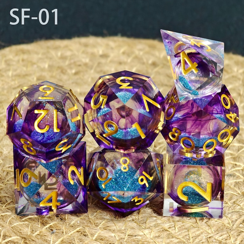 May include: A set of seven polyhedral dice with a purple and blue glitter design. The dice have gold numbering and are made of a clear resin material. The text "SF-01" is in the top left corner.