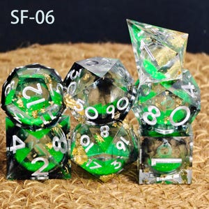 May include: A set of polyhedral dice in green and gold. The dice are transparent with green and gold accents, and white numbers. The text "SF-06" is in the top left corner.