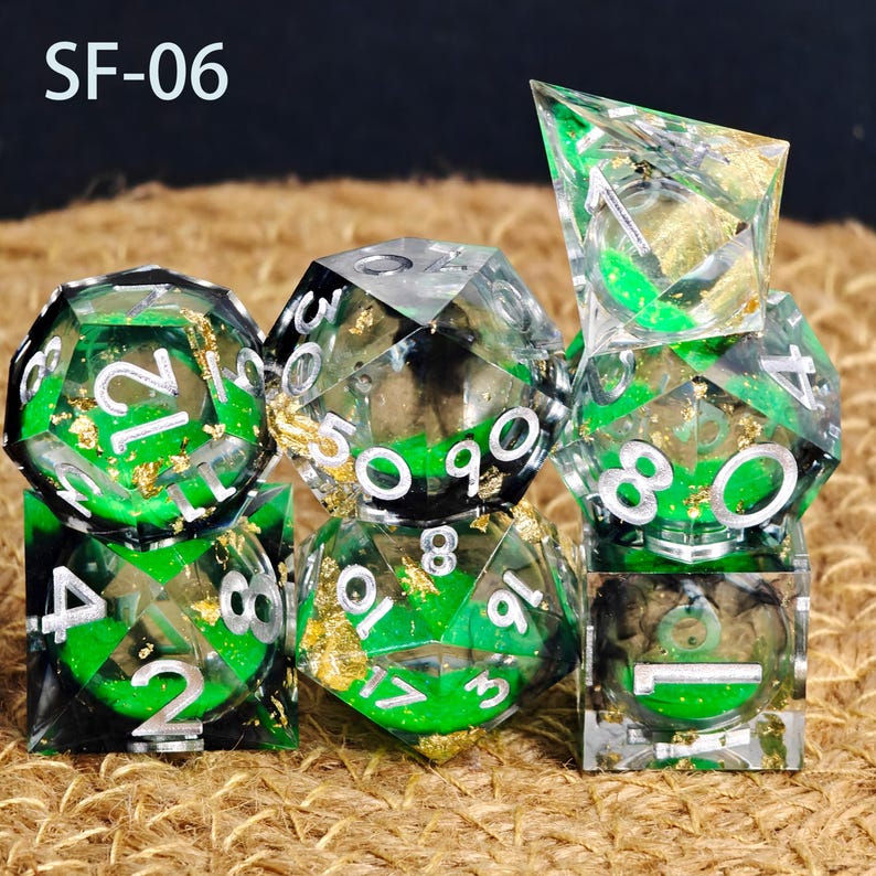 May include: A set of polyhedral dice in green and gold. The dice are transparent with green and gold accents, and white numbers. The text "SF-06" is in the top left corner.
