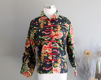 May include: A black floral print jacket with red and yellow accents. The jacket has a mandarin collar and a button closure.