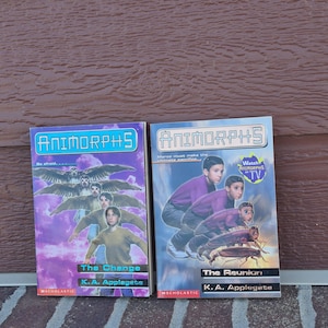 May include: Two paperback books titled "Animorphs: The Change" and "Animorphs: The Reunion" by K.A. Applegate. The covers feature illustrations of children transforming into animals, with a purple and blue color scheme. The books are from Scholastic.