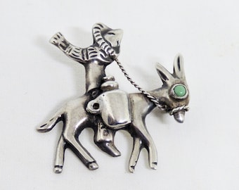 Vintage Hand Made Mexican Sterling Silver And Turquoise Brooch Of A Mexican Wearing A Sombrero Riding A Donkey Circa 1930s