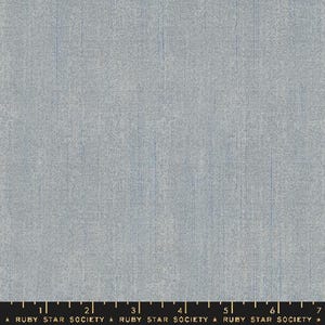 May include: A light blue fabric with a subtle textured pattern. The fabric has a slightly grainy appearance, giving it a rustic feel.