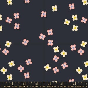 May include: A dark blue fabric with a repeating pattern of pink and yellow flowers. The flowers are scattered randomly across the fabric.