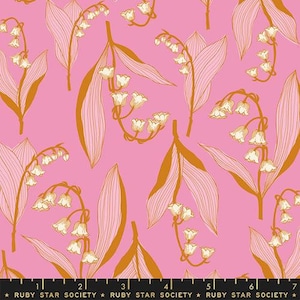 May include: A pink fabric with a repeating pattern of gold lily of the valley flowers and leaves. The fabric has a subtle texture and a soft, feminine feel.