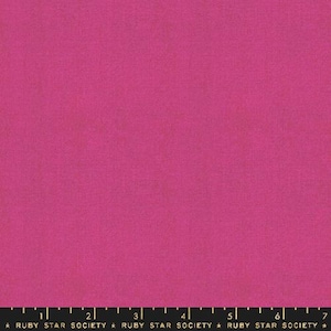 May include: Solid fuchsia pink fabric with a subtle texture. The fabric is marked with a ruler and the text "Ruby Star Society".