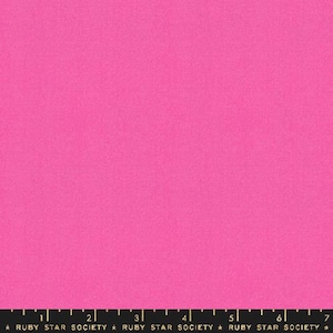 May include: Solid pink fabric with a slightly textured surface. The fabric is a solid color with no pattern or design.