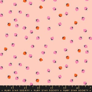 May include: A light pink fabric with a scattered pattern of pink and orange strawberries. Each strawberry has a black stem. The fabric has a ruler at the bottom with the text "RUBY STAR SOCIETY".