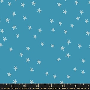 May include: Blue fabric featuring a pattern of light blue stars. The stars are in a hand-drawn style, scattered across the surface. The fabric has a solid blue background. The text "RUBY STAR SOCIETY" is at the bottom.