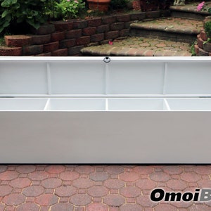 May include: White storage bench with a hinged lid and three compartments. The lid is open, revealing the empty compartments.