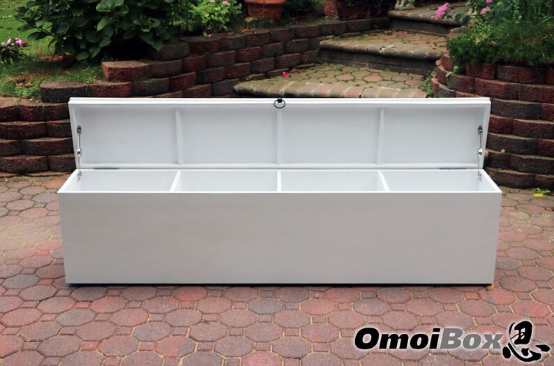 May include: White storage bench with a hinged lid and three compartments. The lid is open, revealing the empty compartments.