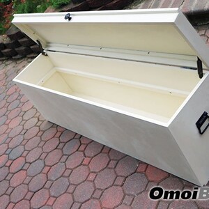 May include: White wooden storage bench with a hinged lid and a black handle. The lid is open, revealing the empty interior of the bench.