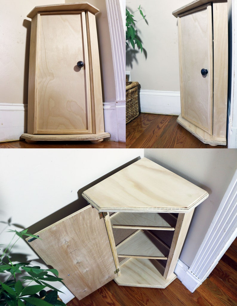 May include: A light wood corner cabinet with a single door and three shelves. The cabinet is open and the shelves are visible.